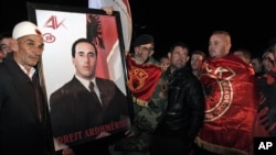 Supporters of former ethnic Albanian rebel commander and former Kosovo Prime Minister Ramush Haradinaj, await his arrival in capital Pristina, Kosovo on Thursday, Nov. 29, 2012.