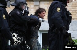 Riot police arrest a protester at a march by demonstrators during the G-7 Summit in Quebec City, Quebec, Canada, June 7, 2018.
