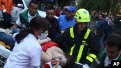 An injured woman is evacuated on a gurney after an explosion at the Centro Andino shopping center in Bogota, Colombia, June 17, 2017. 