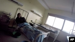 FILE - Detained patients lie on beds in the Kenyatta National Hospital in Nairobi, Kenya, Aug. 6, 2018.