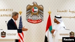 U.S. Secretary of State John Kerry (L) reaches out to shake hands with UAE Foreign Minister Abdullah bin Zayed Al Nahyan at the foreign ministry in Abu Dhabi, Nov. 11, 2013.