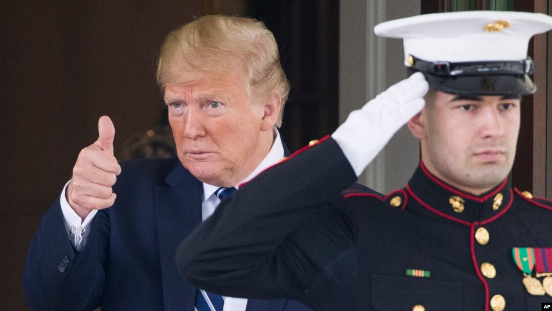 President Donald Trump gives thumbs up to the media as Canadian Prime Minister Justin Trudeau departs the White House, June 20, 2019, in Washington.