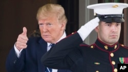 President Donald Trump gives thumbs up to the media as Canadian Prime Minister Justin Trudeau departs the White House, June 20, 2019, in Washington.