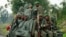 Congolese armed forces (FARDC) soldiers ride on their pick-up truck as they advance to a new position while battling M23 rebels in Kibati near Goma, in the eastern Democratic Republic of Congo, Sept. 2, 2013.