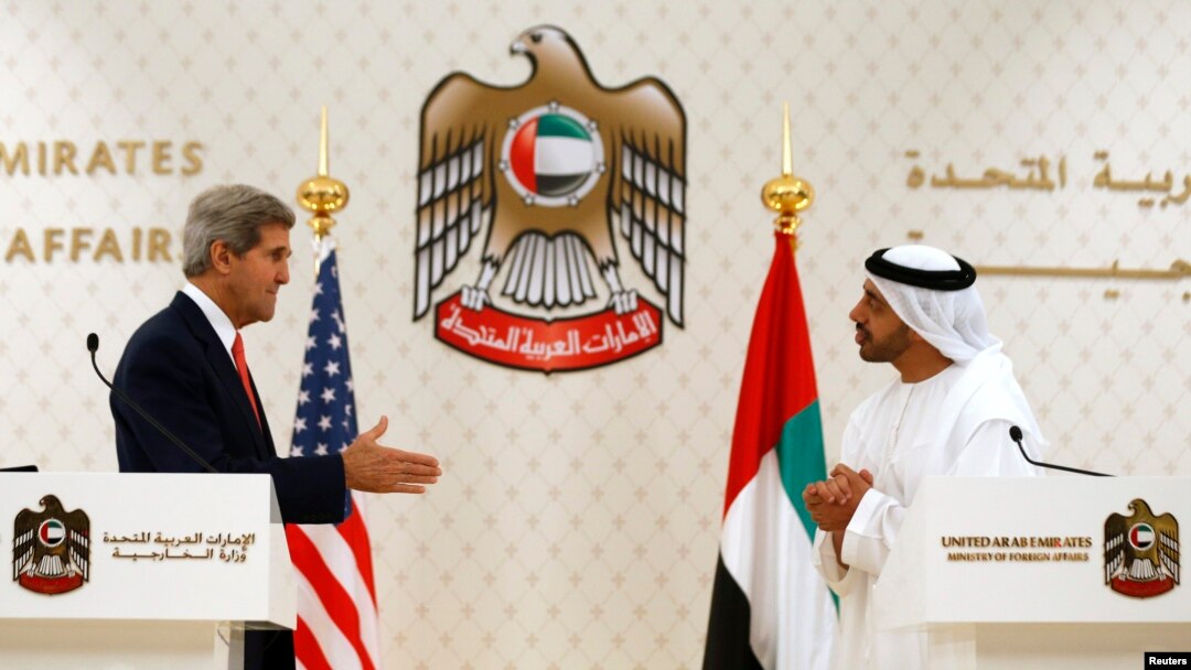 U.S. Secretary of State John Kerry (L) reaches out to shake hands with UAE Foreign Minister Abdullah bin Zayed Al Nahyan at the foreign ministry in Abu Dhabi, Nov. 11, 2013.