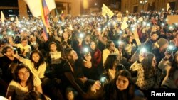 FILE - Supporters of the peace deal signed between the government and FARC gather at Bolivar Square during a march for peace in Bogota, Colombia, Oct. 20, 2016. 