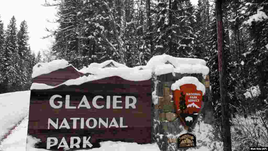 Snow covers the entrance sign to Glacier National Park in December, 2012 in West Glacier, Montana.