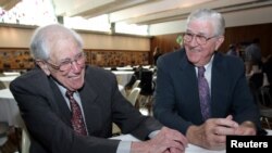 FILE - United Auto Workers past presidents Douglas Fraser, left, and Owen Bieber chat at the 70th anniversary celebration of the UAW at the union's Solidarity House in Detroit, Aug. 26, 2005.