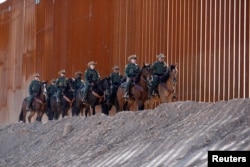 A mounted detachment of the U.S. Border Patrol along the wall during U.S. Department of Homeland Security Secretary Kirstjen Nielsen's visit to the El Centro Sector in Calexico, California, U.S., Oct. 26, 2018.