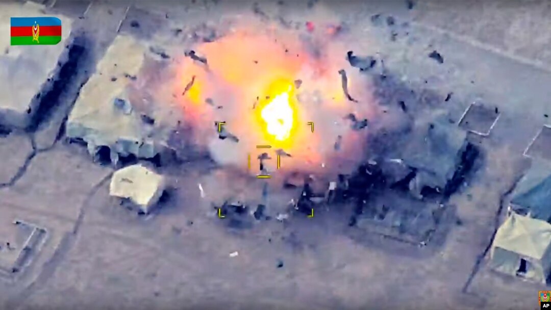 In this photo taken from video released by the Azerbaijan's Defense Ministry Oct. 2, 2020, Azerbaijan's forces attack an Armenian army camp during fighting in the disputed Nagorno-Karabakh region in Azerbaijan.