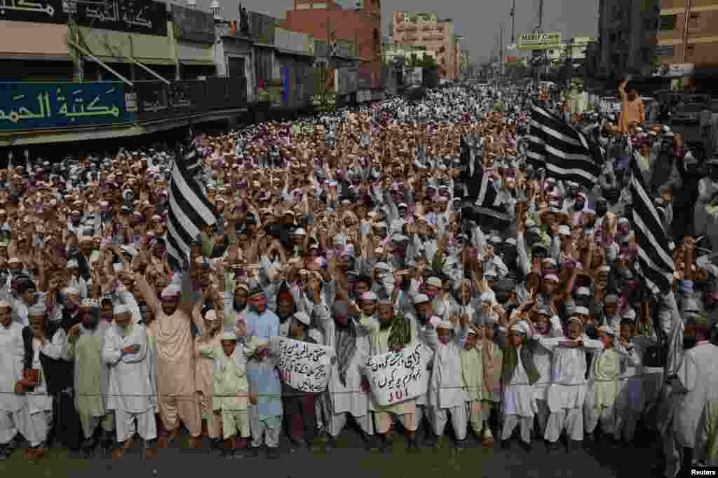 Supporters of Jamiat-Ulema-e-Islam (JUI), one of the largest Sunni political parties, chant slogans during a demonstration against the killing of Sunni Muslim leaders in Karachi. A gunman on a motorcycle shot and killed three leaders on Thursday. Police described the attacks as target killings.