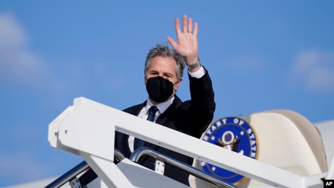 FILE - U.S. Secretary of State Antony Blinken waves as he departs, Jan. 18, 2022, at Andrews Air Force Base, Maryland, en route to Ukraine, Germany and Switzerland.