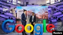 Google CEO Sundar Pichai and Philipp Justus, Google Vice President for Central Europe and German-speaking Countries, stand near a Google logo during the opening of a new Google office in Berlin, Germany, Jan. 22, 2019.
