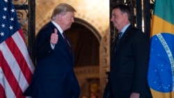 U.S. – U.S. President Donald Trump (L) speaks with Brazilian President Jair Bolsonaro during a dinner at Mar-a-Lago in Palm Beach, Florida. Taken on March 7, 2020