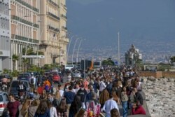 People crowd the Naples waterfront, southern Italy, Nov. 8, 2020. According to Health Ministry figures, there are some 220,00 more people currently positive for COVID-19 discharged or recovered in the entire pandemic.