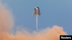 SpaceX's Mars Starship prototype "Starhopper" hovers over its launchpad during a test flight in Boca Chica, Texas, Aug. 27, 2019.
