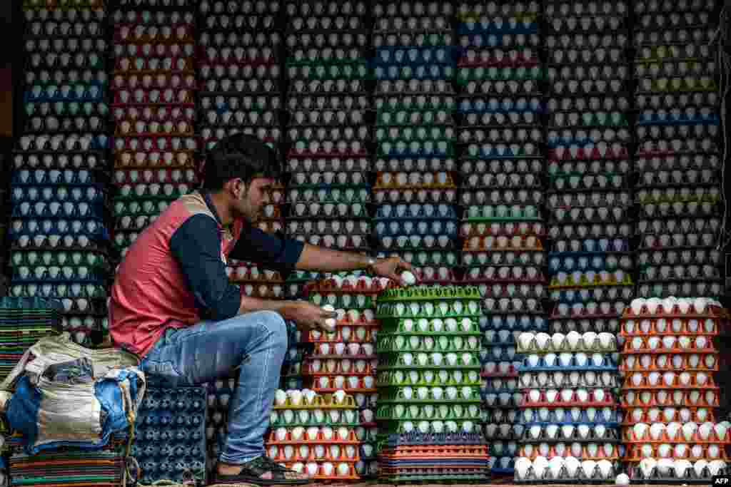 A man arranges eggs for delivery in Mumbai, India.