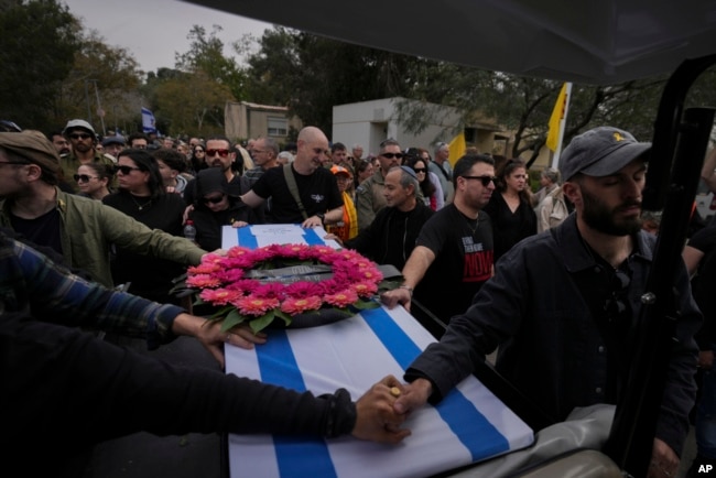 Mourners carry the coffin of Itzhak Elgarat, a slain hostage who was held captive by Hamas in Gaza, during his funeral procession in Kibbutz Nir Oz, Israel, March 3, 2025.