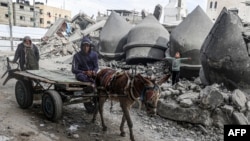 FILE —A man drives a donkey-pulled cart past the rubble of Al-Faruq Mosque, that was destroyed during Israeli bombardment, in Rafah on the southern Gaza Strip on March 17, 2024, amid ongoing battles between Israel and the Palestinian militant group Hamas. 