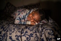 Tshimologo Bonolo, 8, poses for a photograph at her house in Soweto, South Africa, June 26, 2021. She lost her father to COVID-19 in July 2020.