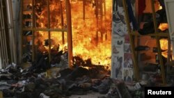 Fire consumes a clothing stall after an explosion at a shopping complex in Nairobi, Kenya, May 28, 2012. 