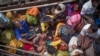 FILE - This photograph taken on Sept. 12, 2017 shows Rohingya refugees arriving by boat at Shah Parir Dwip on the Bangladesh side of the Naf River after fleeing violence in Myanmar.