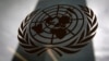 FILE - The United Nations headquarters building is pictured though a window with the UN logo in the foreground in New York, Aug. 15, 2014. 