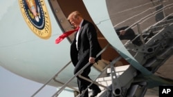 President Donald Trump walks down the stairs of Air Force One during his arrival at Palm Beach International Airport, in West Palm Beach, Florida, March 29, 2018. Trump is spending the weekend at his his Mar-a-Lago estate.