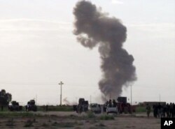 Smoke rises from an explosion as Iraqi forces, Shiite militiamen and Sunni tribal fighters battle Islamic State militants for control of Tikrit, Iraq, March 3, 2015.