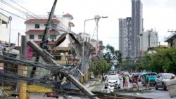 Toppled electrical posts lie along a street in Cebu city, central Philippines caused by Typhoon Rai on Dec. 17, 2021.