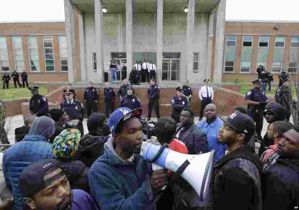 Protesters stand outside the Baltimore Police Department's Western District police station, April 23, 2015, in Baltimore.