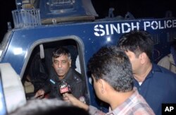 FILE - Pakistani police officer Rao Anwar, who reportedly escaped injury in an attack, talks to reporters in Karachi, Pakistan, Jan. 16, 2018.