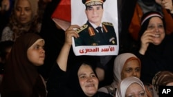 Woman holds poster of Egyptian Defense Minister General Abdul Fatah al-Sisi, Tahrir square, Cairo, July 19, 2013.