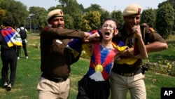 Police try to detain a protesting exile Tibetan during a protest outside Chinese embassy to mark the 1959 uprising in Tibet against the Chinese rule on this day, in New Delhi, March, 10, 2025.