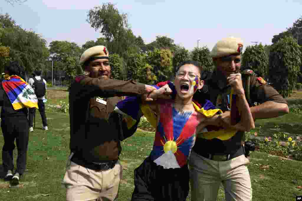 Police detain a protesting exile Tibetan during a protest outside the Chinese embassy to mark the 1959 uprising in Tibet against the Chinese rule on this day, in New Delhi, India.