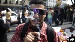 A supporter of the legalization of marijuana smokes outside the Supreme Court in Mexico City, Nov. 4, 2015. 