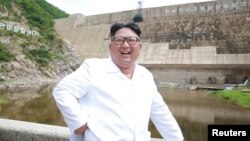North Korean leader Kim Jong Un smiles during his visit to the under-construction Orangchon Power Station in this undated photo released by North Korea's Korean Central News Agency in Pyongyang, July 17, 2018. 