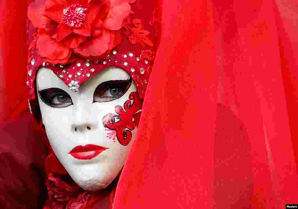 A masked reveler poses during the Venice Carnival in Venice, Italy.