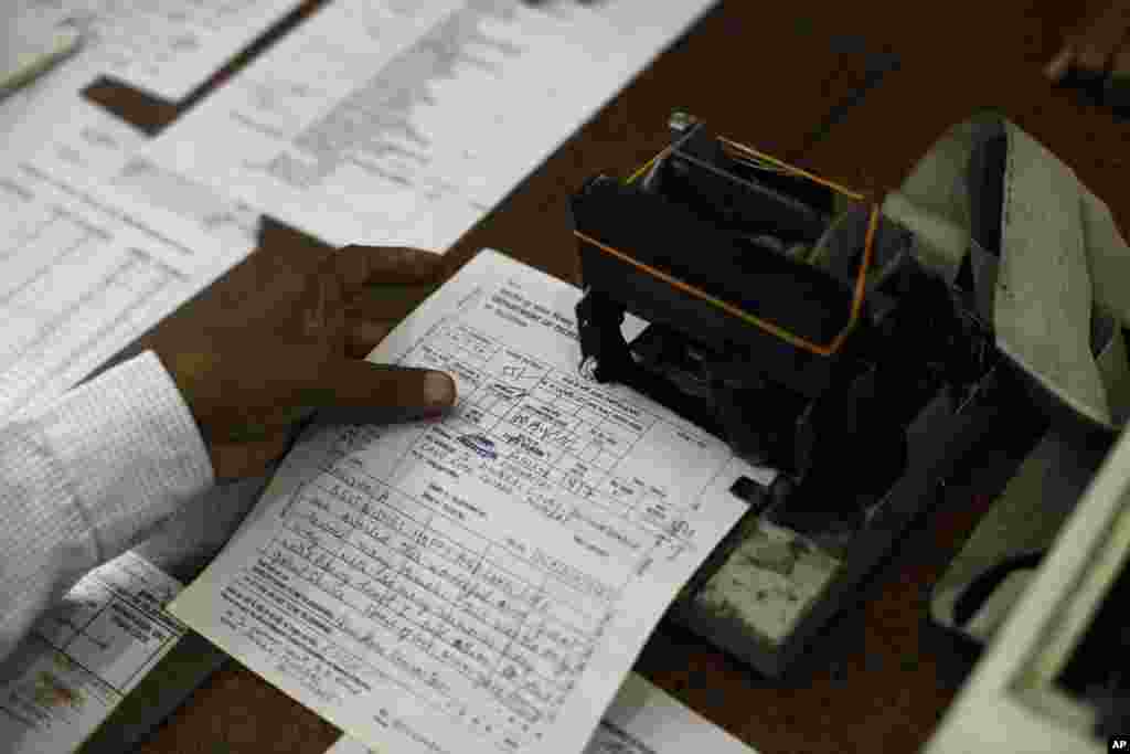 An Indian telegraph employee processes a telegram on the last day of the 163-year-old service at the central telegraph office in Mumbai. Sunday night, the state-run telecommunications company will send its final telegram, closing down a service that fast became a relic in an age of email, reliable landlines and ubiquitous cellphones.