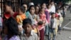 FILE - Cambodian villagers for countryside line up as wait for a medical check-up outside the children hospital of Kuntha Bopha, in Phnom Penh, Cambodia, July 11, 2012. 