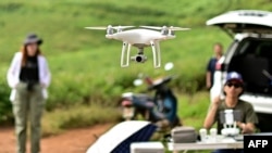 FILE - This picture taken on November 22, 2023 shows a drone being flown by Chiang Mai University's Forest Restoration Research Unit (FORRU) field research officer Worayut Takaew during a mapping survey of a reforested area on a hillside near Chiang Mai.