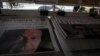 FILE -A man looks at newspapers at a stall a day after general election in Islamabad, Pakistan, July 26, 2018. 