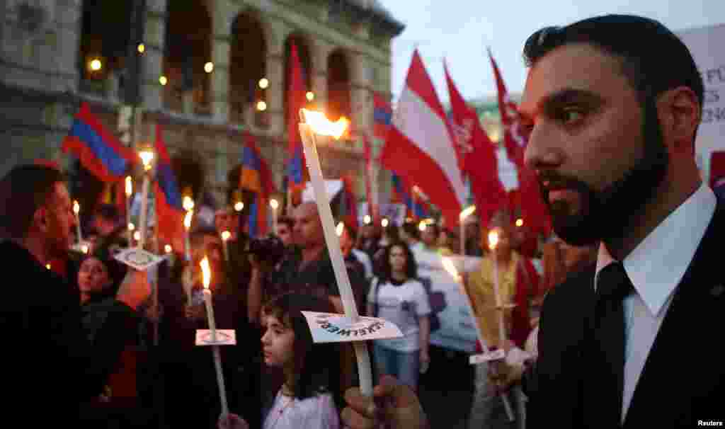Demonstrators pass the State Opera during a torch-bearing march marking the centenary of the mass killing of Armenians by Ottoman Turks, in Vienna, April 24, 2015. An Austrian parliamentary declaration describes the killings as &#39;genocide&#39;, a term that the Austrian government had long rejected.