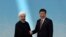 2014年5月21日，习近平在上海与出席亚信峰会的伊朗总统鲁哈尼握手