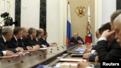 President Vladimir Putin heads a meeting of Russia's Security Council in Moscow's Kremlin July 22, 2014. Nikolai Patrushev is the third from the left.