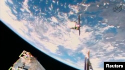 FILE - A Cygnus commercial resupply craft makes its final approach before docking at the International Space Station, as seen in this NASA image from video taken Jan. 12, 2014. 