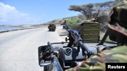 Soldiers patrol the seaport in Somalia's southern port city of Kismayo, November 29, 2012.