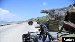 FILE - Soldiers patrol the seaport in Somalia's southern port city of Kismayo, Nov. 29, 2012.