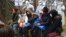 Migrants wait for an appointment with a Belarusian doctor at checkpoint "Kuznitsa" at the Belarus-Poland border near Grodno, Nov. 24, 2021. The EU has accused Belarus' government of orchestrating a migration surge in retaliation for EU sanctions. Belarus denies the assertion.