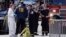 Boston firefighters, right, talk with FBI agents and a crime scene photographer at the scene of Monday's Boston Marathon explosions, which killed at least three and injured more than 140, in Boston, April 16, 2013. 